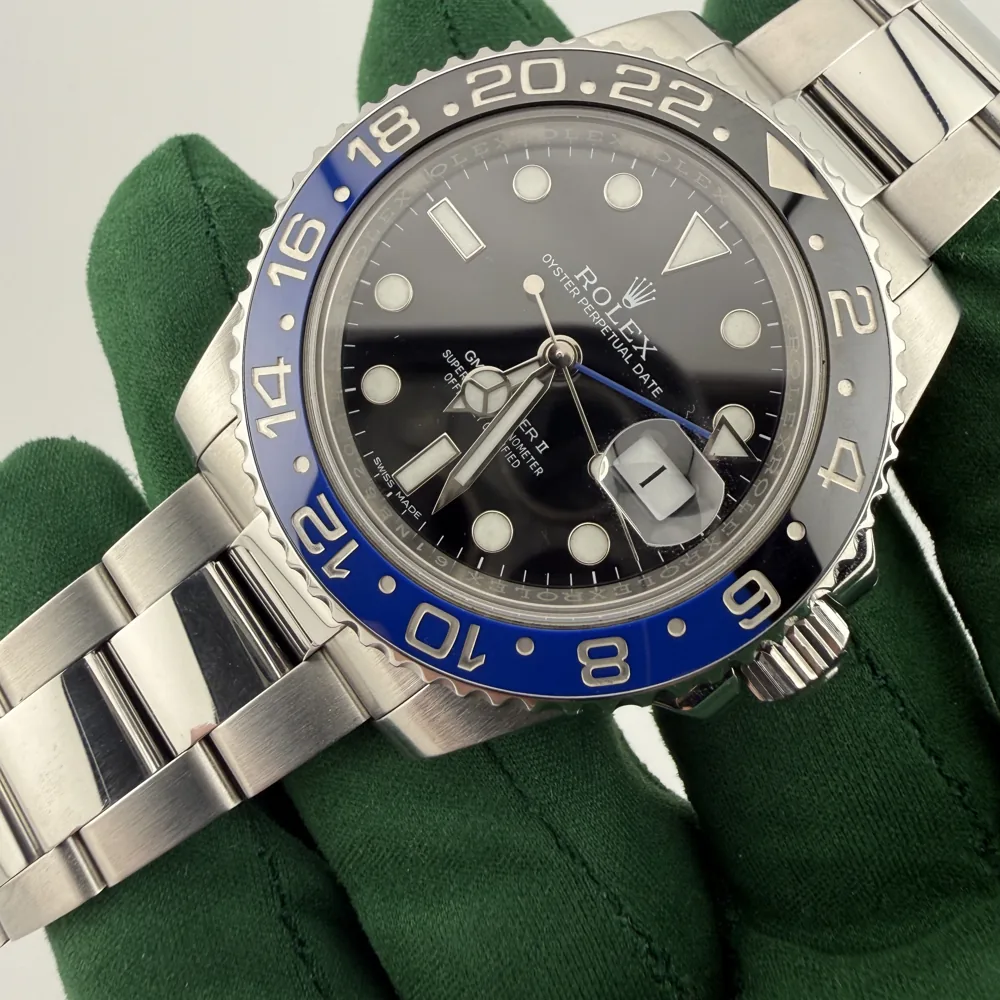 Rolex GMT-Master II 116710BLNR Batman, blue and black ceramic bezel, dial view in a green glove