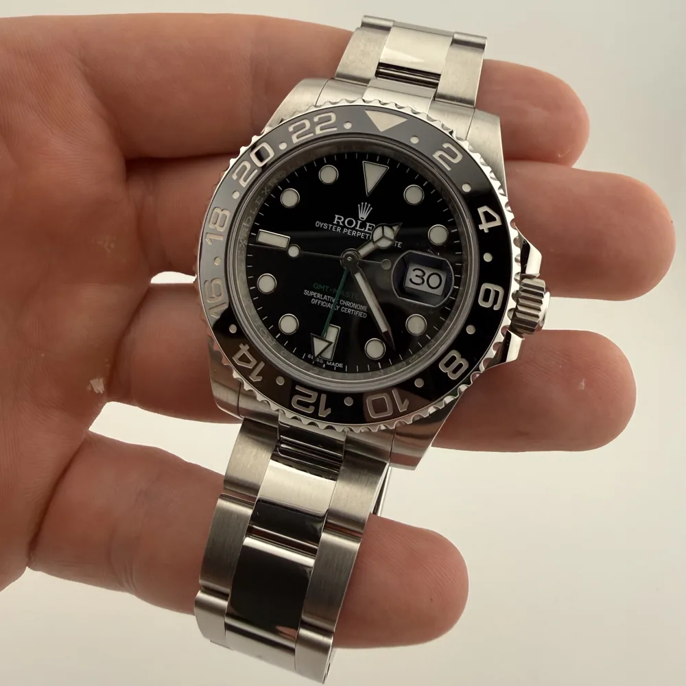 Rolex GMT-Master II 116710LN Bruce Wayne, black ceramic bezel, dial view in hand