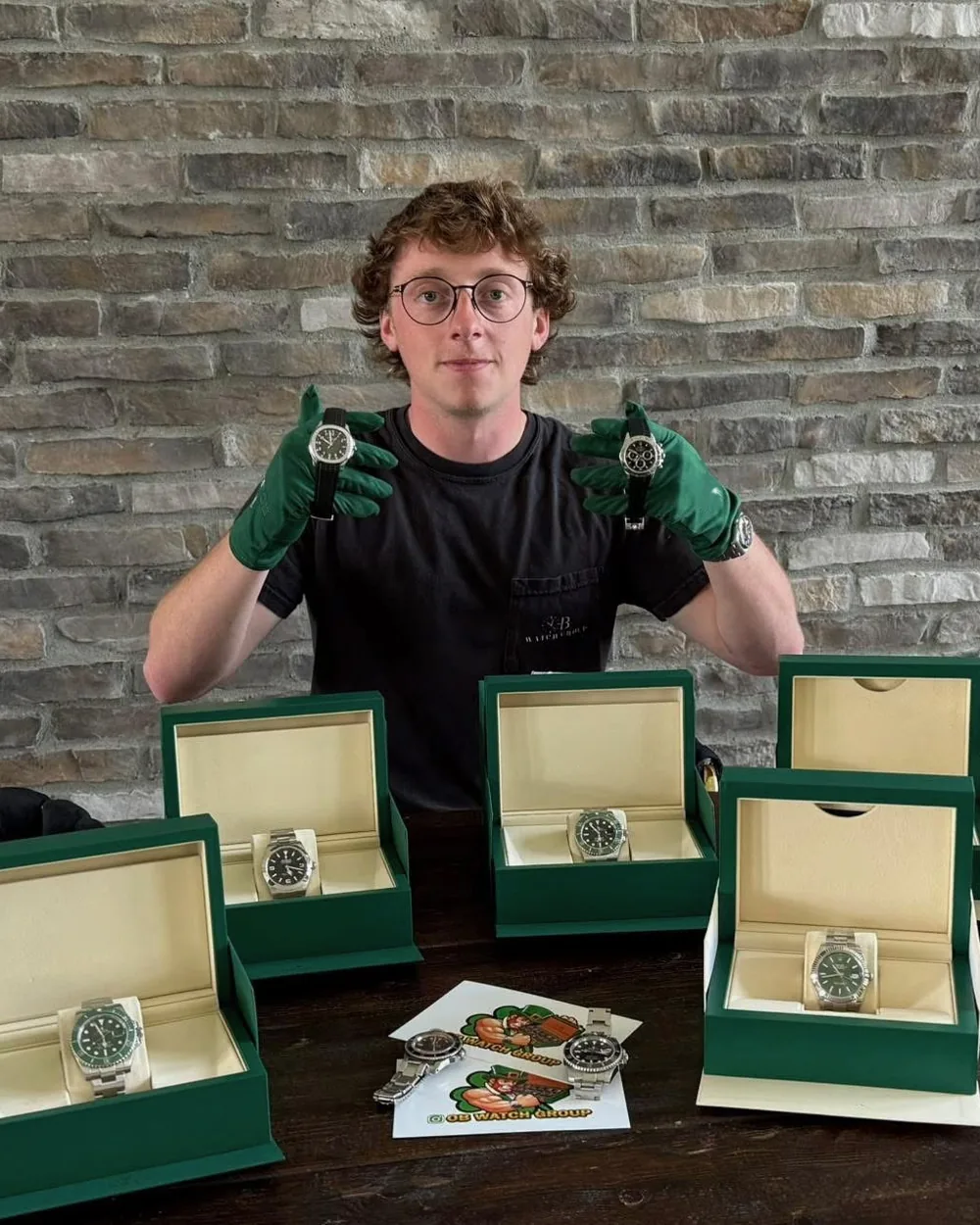 Luke O'Brien, founder of OB Watch Group, in green gloves behind a row of open watch boxes