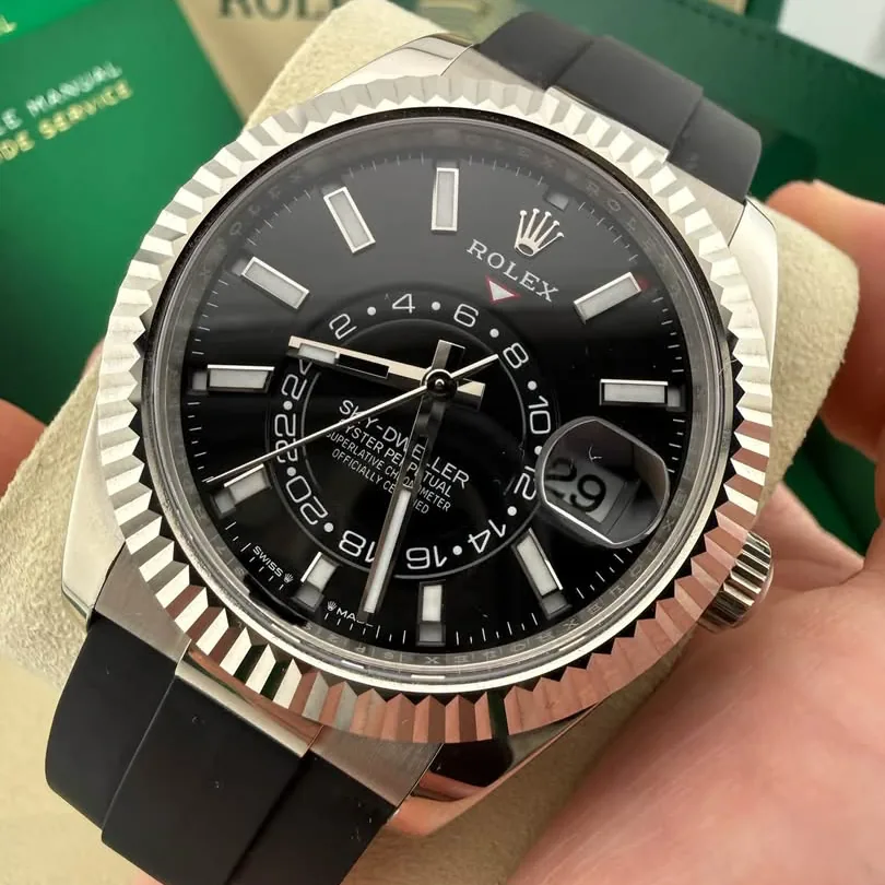 Rolex Sky-Dweller 336239 in 18k white gold, black dial, held in hand showing the dial and fluted bezel
